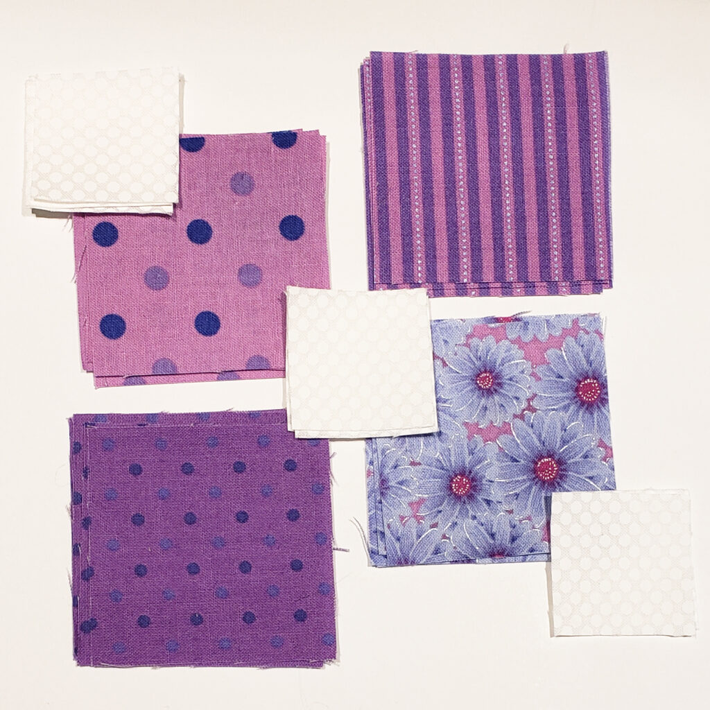 Image of cute purple and creme colored quilting pattern scraps