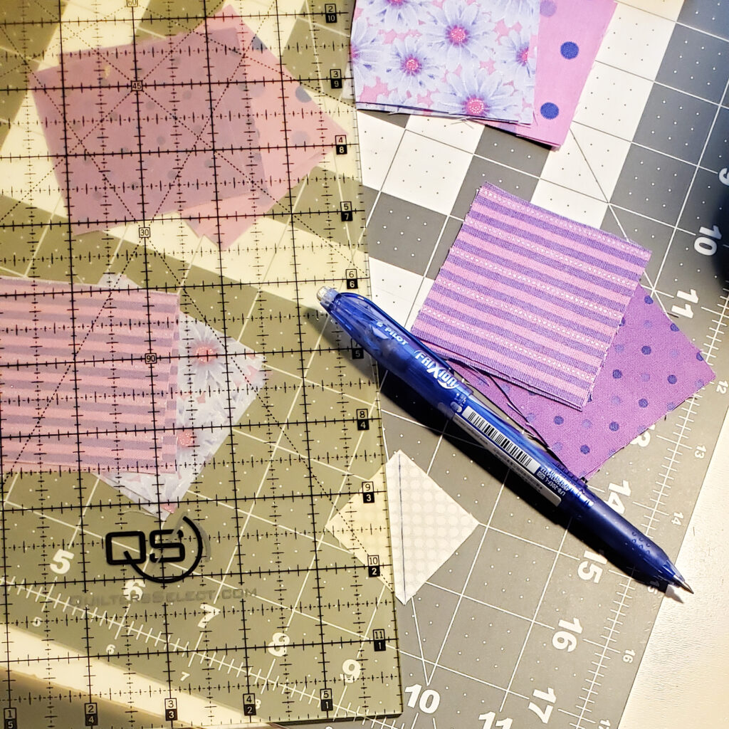 Image of quilting pattern scraps with a ruler and pen