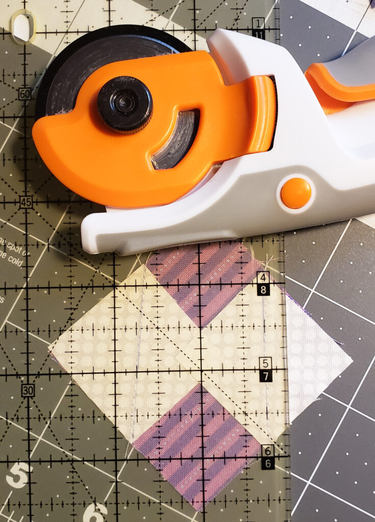Image of a fabric cutter on top of a ruler