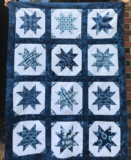 Paula's quilt which had a dark blue border and blue stars and triangles